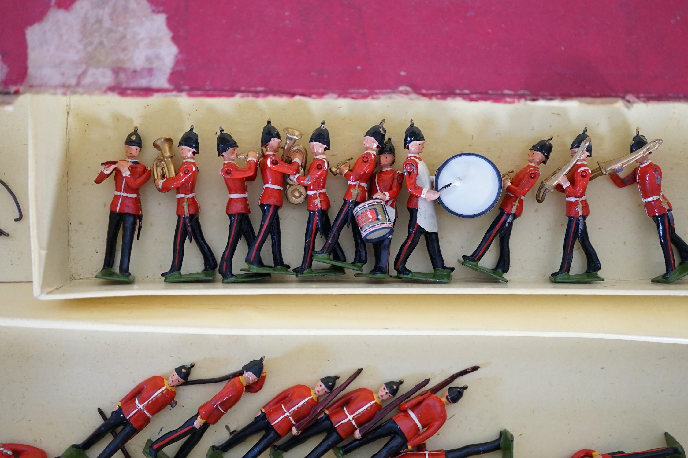A Britains ‘Regiments Of All Nations’ series box of lead soldiers, including twelve Scottish Highlander infantrymen, eleven marching bandsmen
